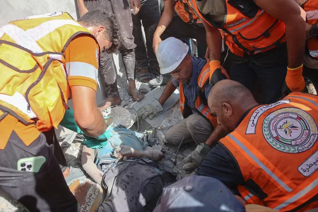 Palestijnse reddingswerkers halen een lichaam op na een Israëlische aanval in Gaza-stad op 17 september 2024, te midden van de aanhoudende oorlog tussen Israël en Hamas.